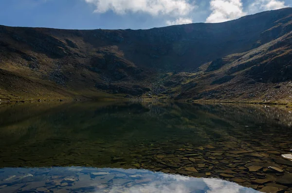 Mind blowing mirror like lake reflections . Lake Salzata (The Teardrop) one of a group of glacial lakes in the northwestern Rila Mountains in Bulgaria. Autumn 2018