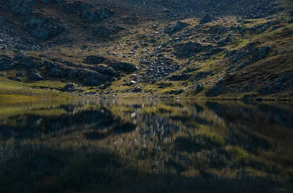 Mind blowing mirror like lake reflections . Lake Salzata (The Teardrop) one of a group of glacial lakes in the northwestern Rila Mountains in Bulgaria. Autumn 2018