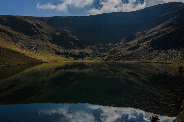 Mind blowing mirror like lake reflections . Lake Salzata (The Teardrop) one of a group of glacial lakes in the northwestern Rila Mountains in Bulgaria. Autumn 2018