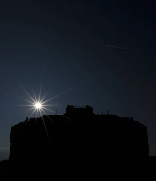 Sunbeams on a dark sky over National Palace of Culture, Sofia, Bulgaria