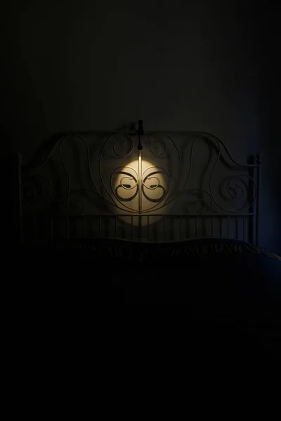 Bed frame lighted by a lamp
