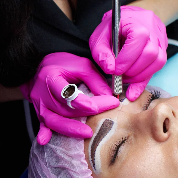 hand master with tool for microblading, training in permanent makeup