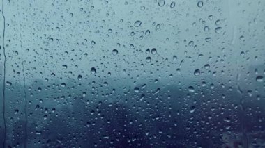 Yağmur. Cama yağmur damlaları damlıyor. Pencerenin dışında yağmur yağıyor..