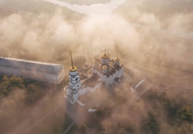 An incredibly beautiful misty morning over Vladimir. Aerial view on Assumption Cathedral in the fog. Russia. Vladimir clipart