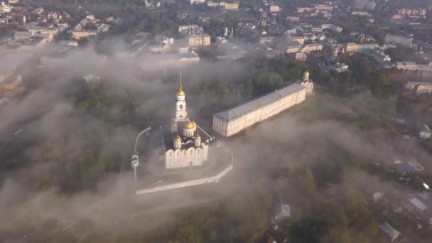 Туманное утро над Успенским собором во Владимире. Облака тумана пролетают над собором. Вид с высоты птичьего полета . — стоковое видео