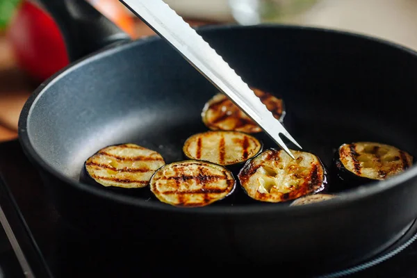 Les aubergines sont frites dans une poêle. Gros plan . — Photo