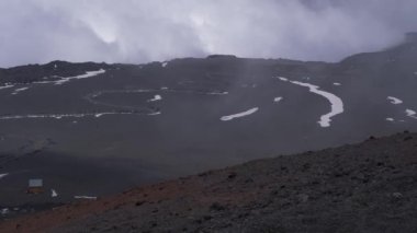 Yanardağ Etna yüzeyinin panoramik görünümü. Dağın tepesine giden yol. Yanardağ üzerinde bulutlar. Sicilya, Italya.