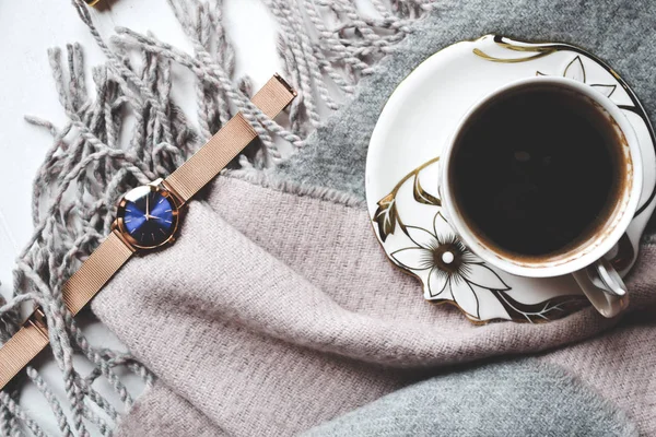 Cozy morning with a cup of coffee, woolen plaid and beautiful details. Atmosferic flat lay. Hygge style.