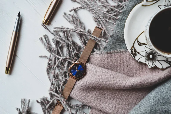 Cozy morning with a cup of coffee, woolen plaid and beautiful details. Atmosferic flat lay. Hygge style.