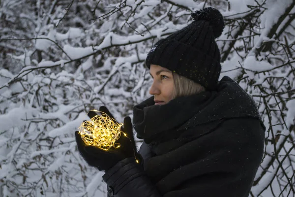 Vrouw Houdt Festoen Lichten Een Winter Park — Stockfoto