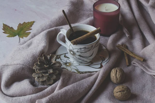 A cup of coffee with cinnamon. Cozy atmosphere.
