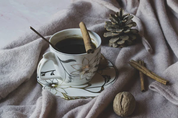 A cup of coffee with cinnamon. Cozy atmosphere.