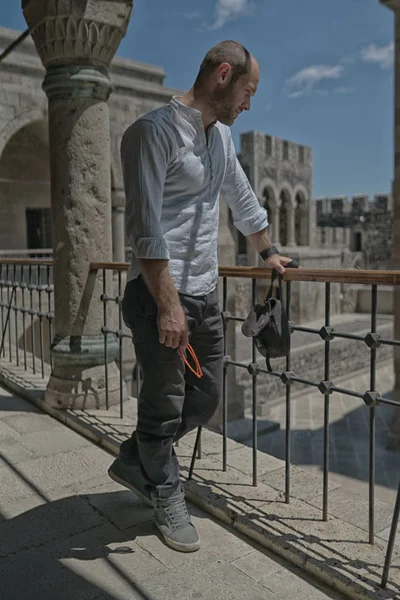 Modelo homem com óculos de sol e camisa branca no antigo castelo georgiano — Fotografia de Stock