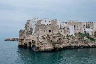 A Mare apulia İtalya Polignano kıyılarında kayaların üzerinde eski evler