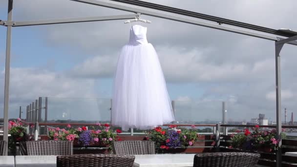 White Wedding dress hanging on a hanger — Stock Video