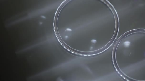 Silver Wedding Rings on glass table macro closeup shoot diamon Jewellery — Stock Video