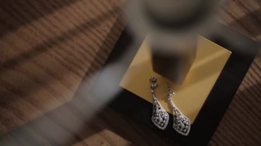 Gelin Mücevherat için lamba altında küpe süslemeleri, kurdeleler, saten süslemeleri ve takı düğün