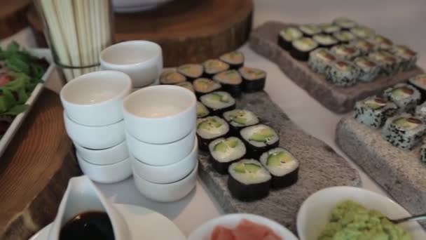 Sushi Snack on the tray On a sunny day on a white tablecloth — Stock Video