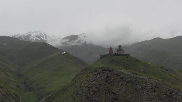 Kazberi Miuntains Gergeti Trinity Church in Georgia drone flight — Stock Video