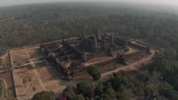 Angkor Wat Temple in Cambodia sunrise fog drone flight — ストック動画