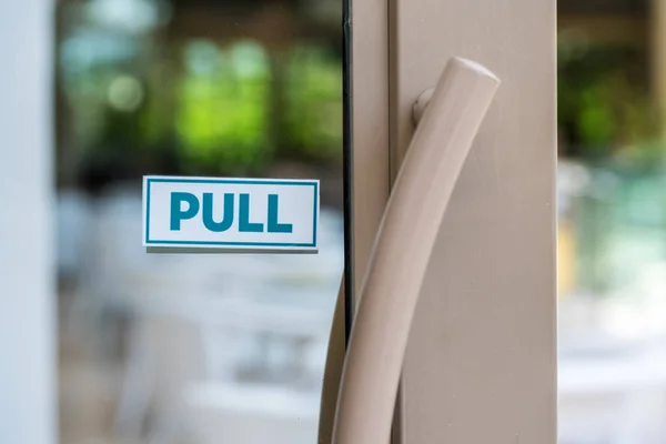 pull the door sign on glass door