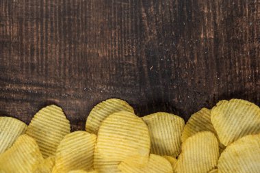 Gevrek patates cipsi ahşap zemin üzerine yığını