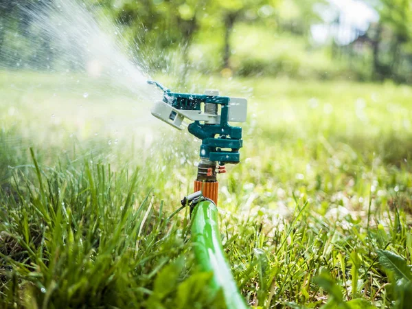 close up garden lawn  irrigation system sprinkers splashes