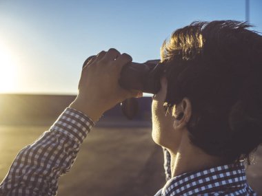 dürbün ile doğru yolu arayan genç adam
