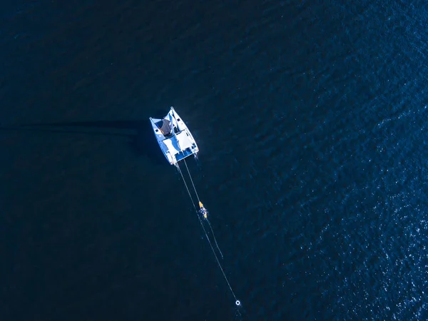 aerial top down view of sport sail yacht on the water sea texture isolated