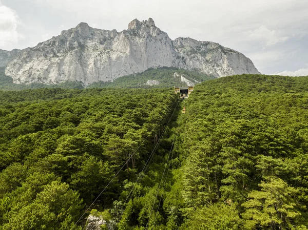 aerial funicular cableway move to the top of the mountain during summer season