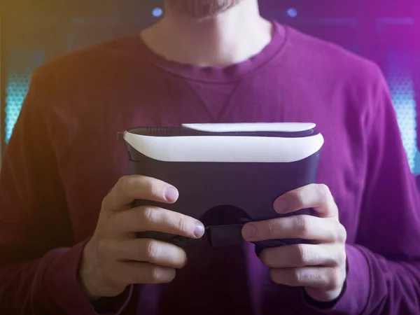 close up person holds the virtual reality glass in fron of chess with okay sign