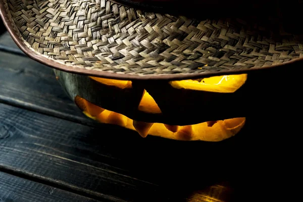 close up cut out lighten jack o lantern in hat on dark background on halloween f