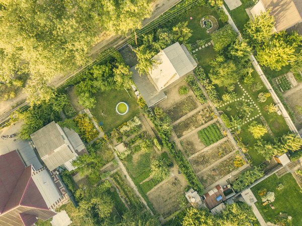 Aerial drone shot of summer countryside cottage with garden