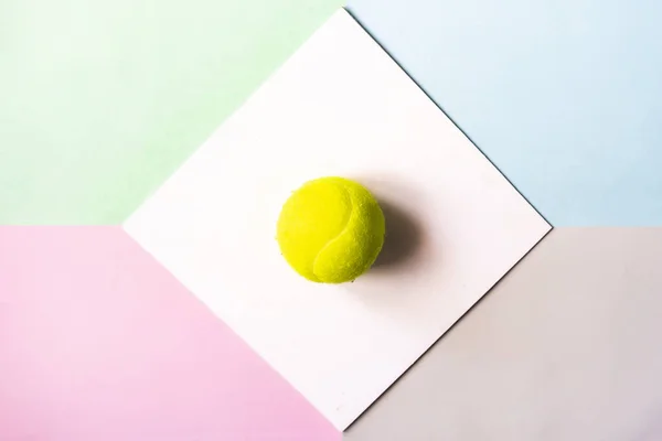 creative flat lay with tennis bal isolated in white frame on color background mock up, creative idea concept f