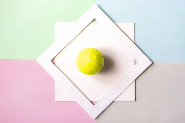 creative flat lay with tennis bal isolated in white frame on color background mock up, creative idea concept f