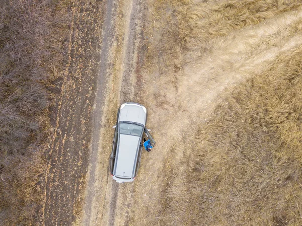 Aerial top view of the car on the road off road in countryside on a rainy day f — Stock Photo, Image