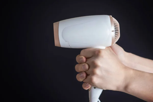 Person hold white hair dryer in his hand isolated b — Stock Photo, Image