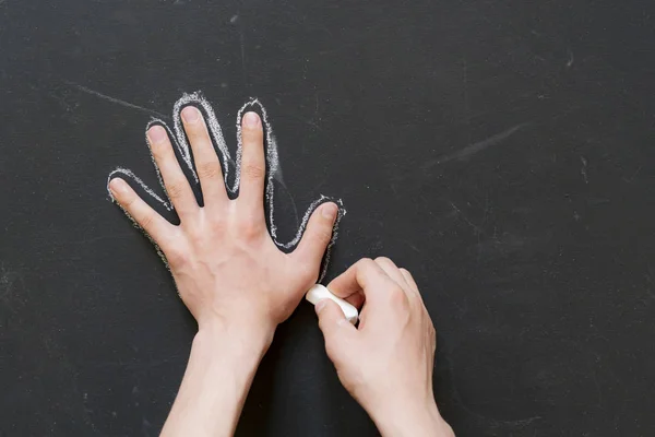 Hand hold piece of chalk and draw a circuit of other hand f — Stock Photo, Image