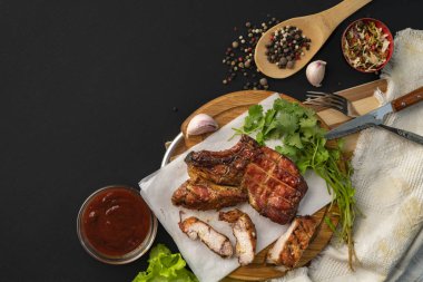 Izgara ribeye sığır eti biftek, ot yaprakları ve baharatlar etrafında, metinler için kopya alanı ile üst görünümü