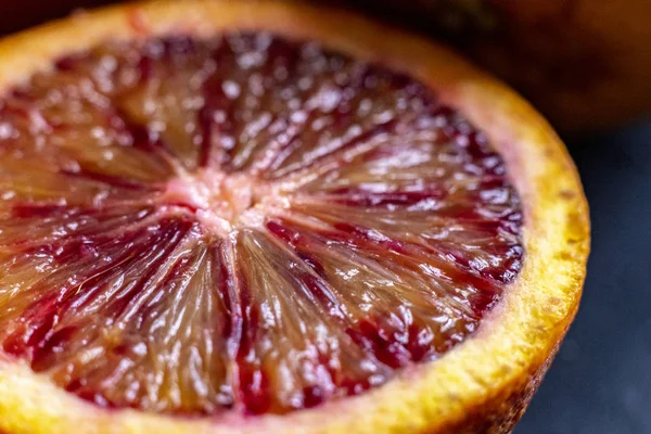 Macro shot of sliced red orange, dark food photo, exotic fruit — Stock Photo, Image