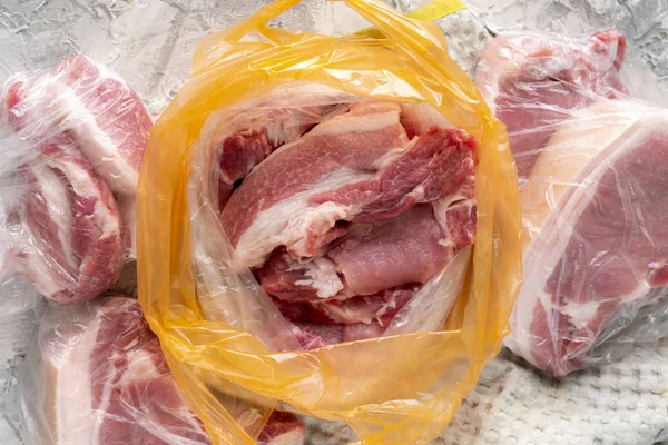 Fresh bloody raw meat in a plastic bag straight after purchasing it at the butcherss — Stock Photo, Image