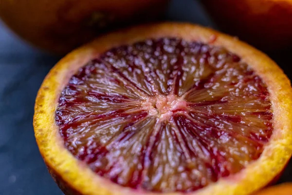 Macro shot of sliced red orange, dark food photo, exotic fruit — Stock Photo, Image