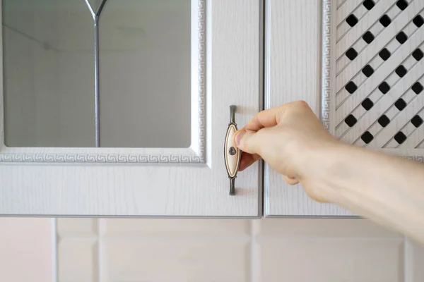 Close up person hand opens wooden shelf at home — Stock Photo, Image