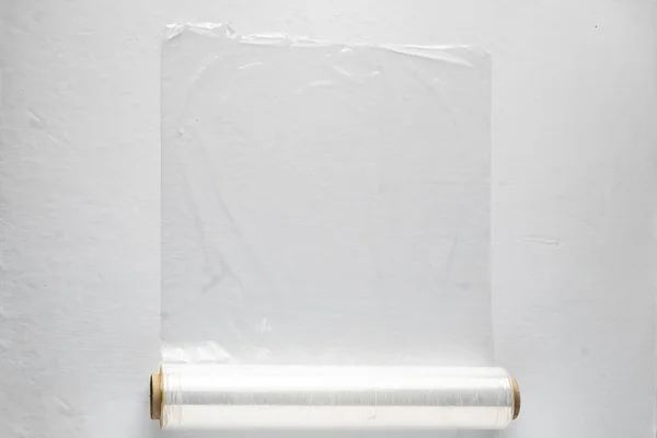 roll of wrapping stretch film for packing at colorful background isolated
