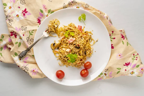 cooked hot meal or dish with spaghetii crab meat mushrooms and spice