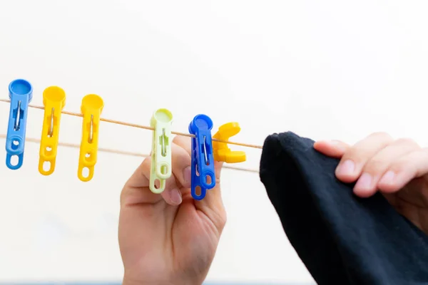 hand hanging the socks with clothespins after laundrys