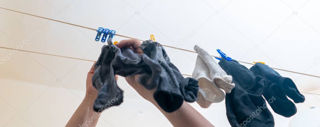 hand hanging the socks with clothespins after laundrys