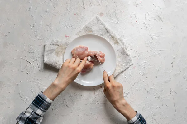 人の手の上の眺めは、プレートの中で生の調理されていない肉を食べる — ストック写真