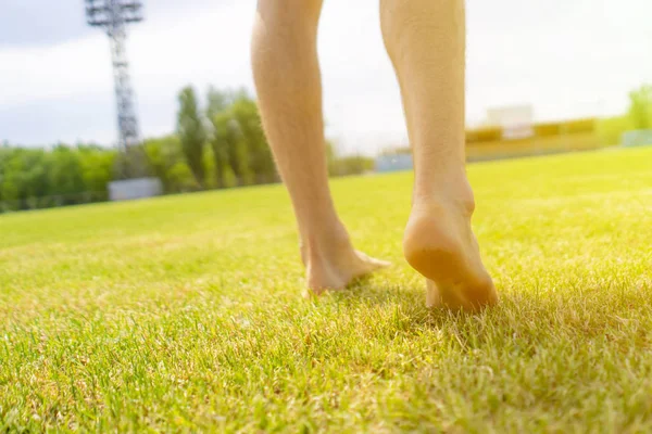 bare feet walking on the lawn grass field, healthy lifestyles practice yoga