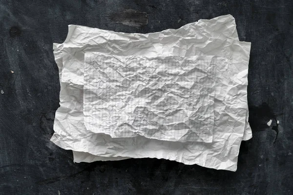 Flat lay crumpled white paper sheet isolated on the table, background texture and copy spaces — Stock Photo, Image